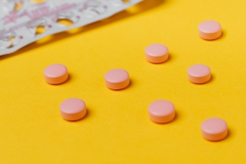 Canva - Pink Pills on Yellow Surface
